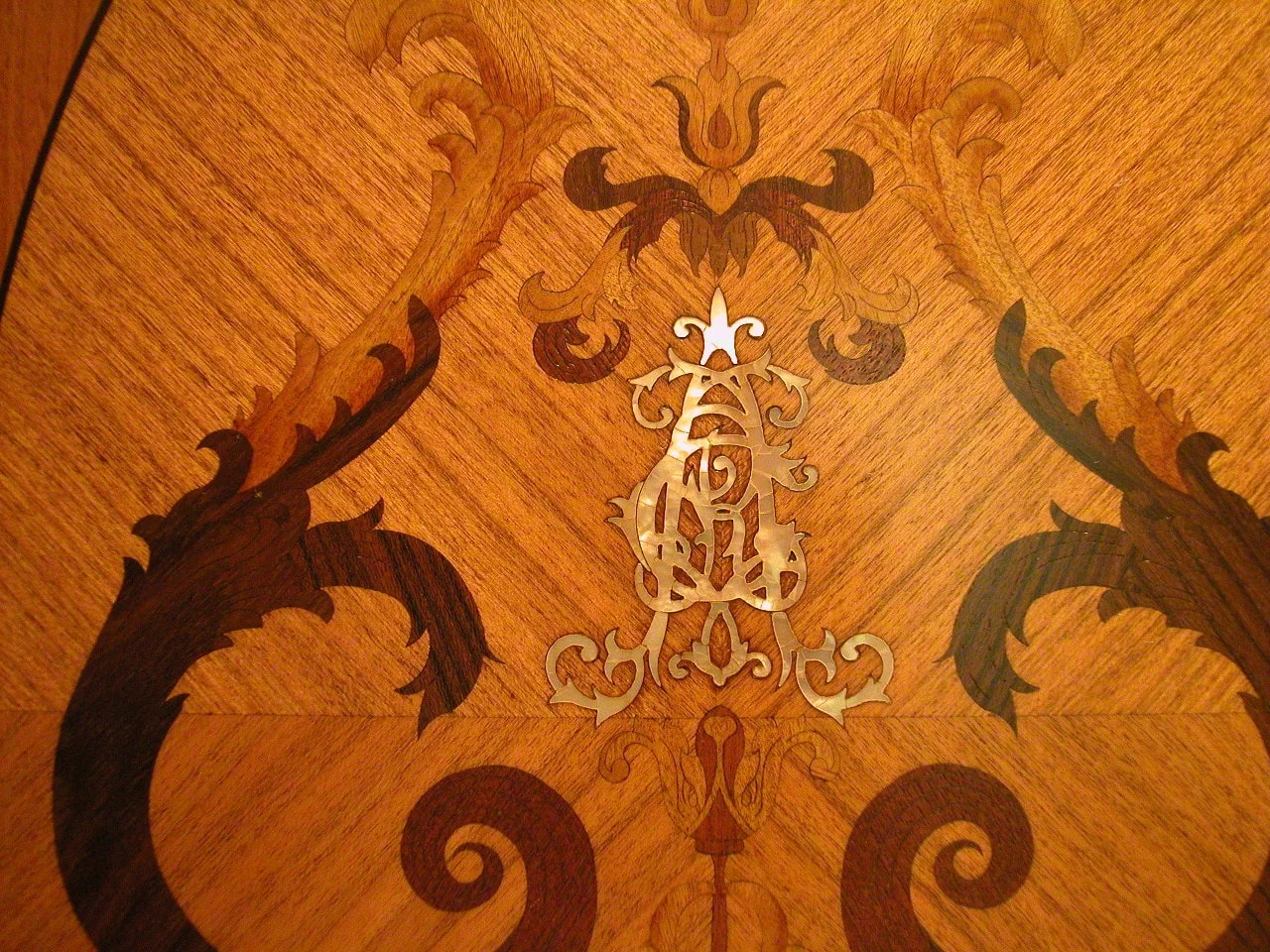 Detailed marquetry composed from contrasting natural wood veneers.