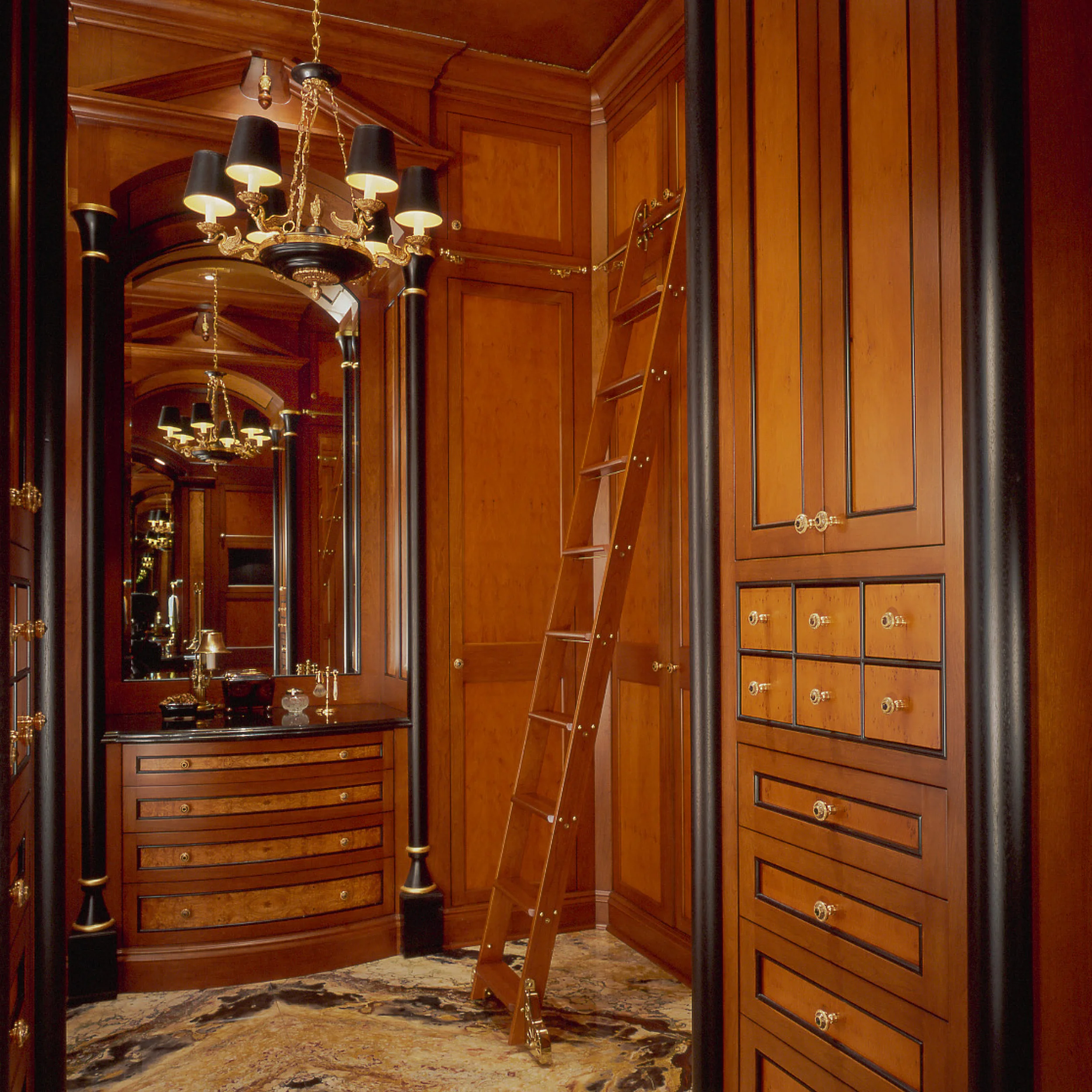 Custom dressing cabinetry with integrated storage, drawers, and detailed wood finishes.